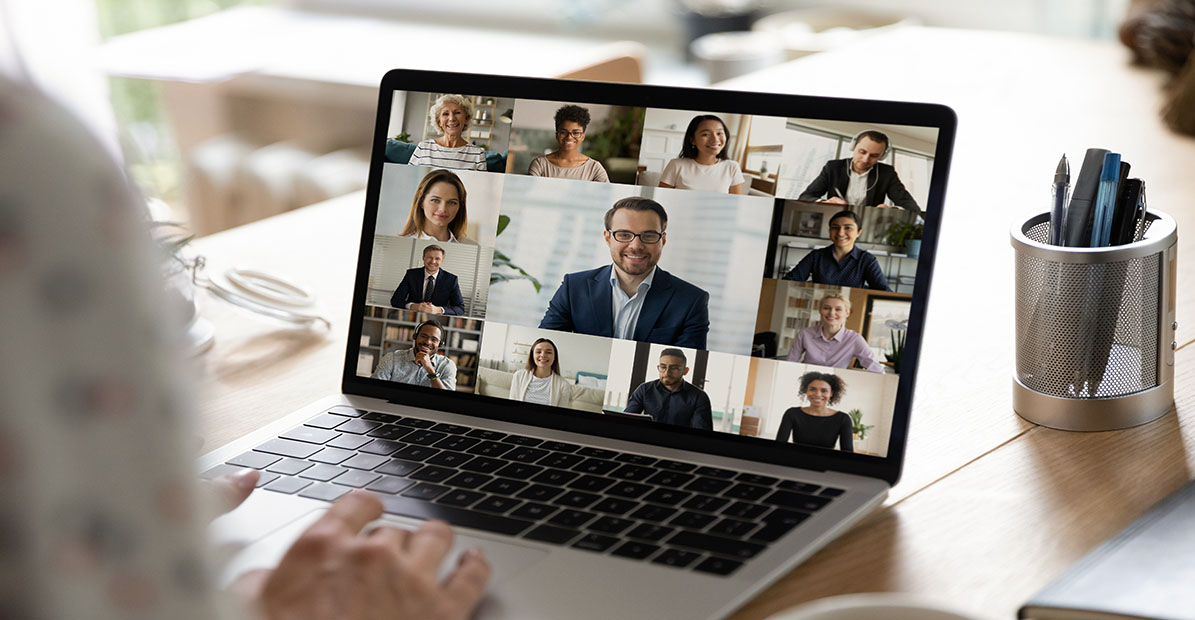Close up back view of worker talk with multiracial businesspeople on video call at home office. Female employee have webcam digital virtual conference online meeting with diverse colleagues.