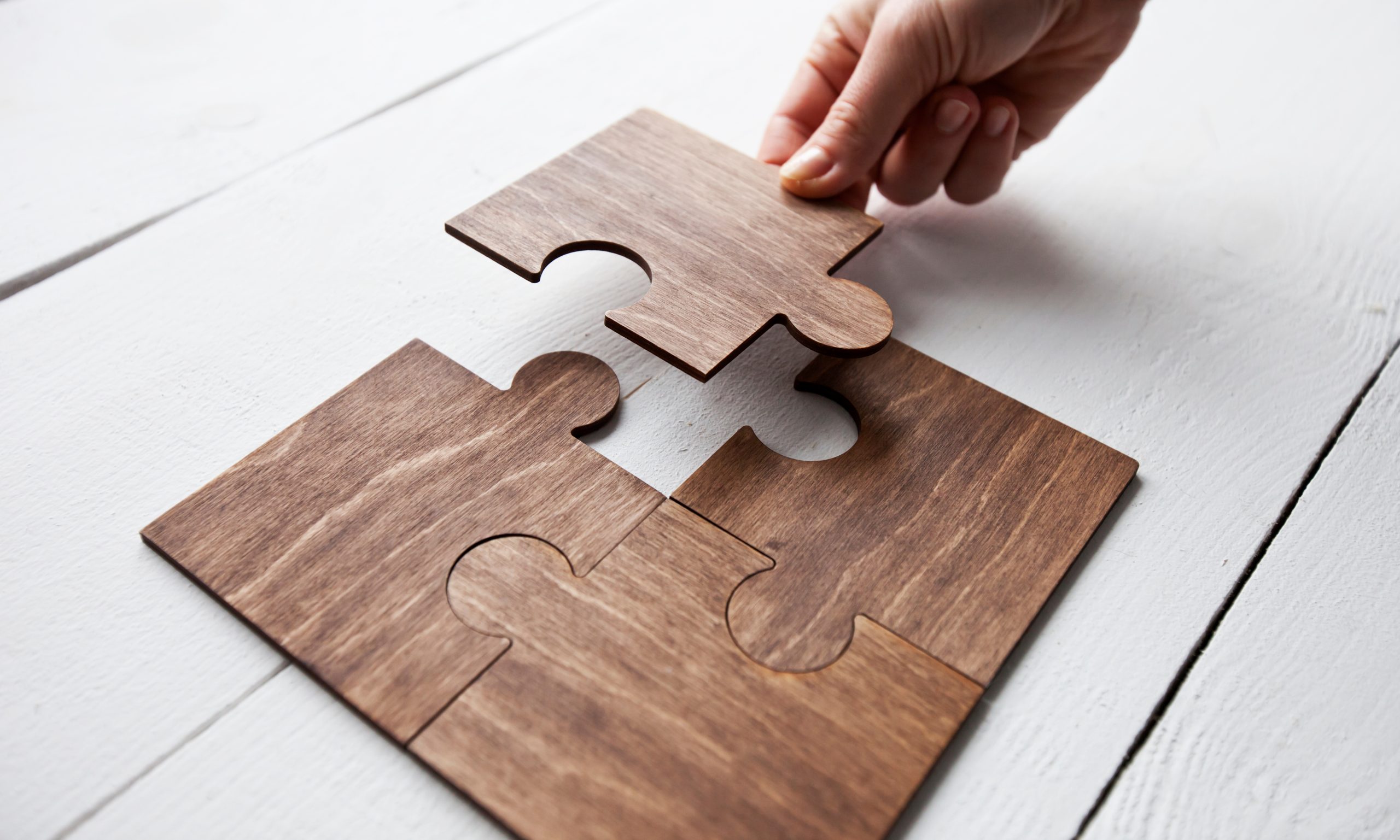 The woman hand connecting puzzles to each other